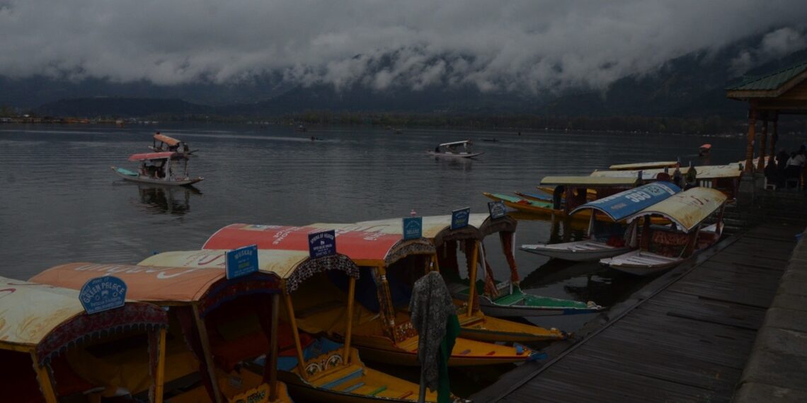Colorful Shikara boats docked on Dal Lake under a moody, cloudy sky