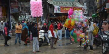 Toy and candy sellers braving rain in Srinagar, just a day before Eid-ul-Fitr, as shoppers flock to markets for festive celebrations.