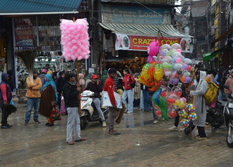 Toy and candy sellers braving rain in Srinagar, just a day before Eid-ul-Fitr, as shoppers flock to markets for festive celebrations.