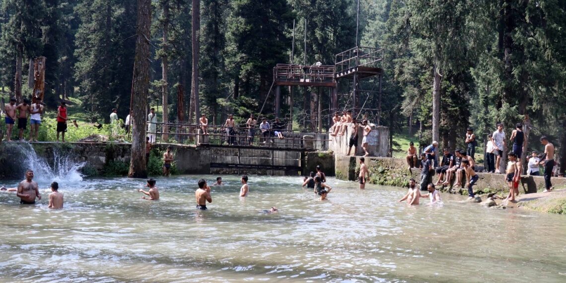 Beating the Heat: Boys taking bath in a stream at Hajan, Budgam